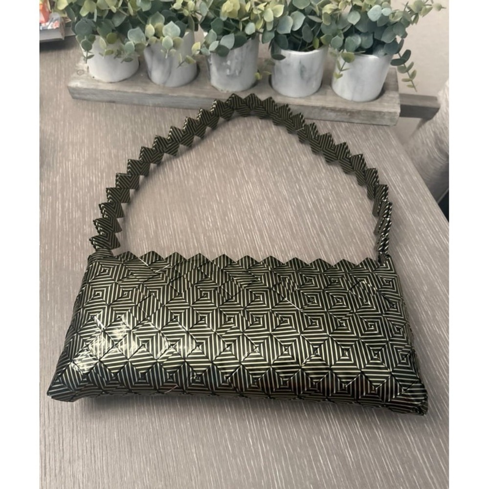 Nahui Ollin black clutch purse with strap.